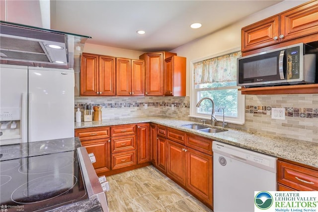 236 Moorestown Rd, Bushkill Twp, PA 18091 - kitchen with white appliances, brown cabinetry, light stone countertops, tasteful backsplash, and recessed lighting