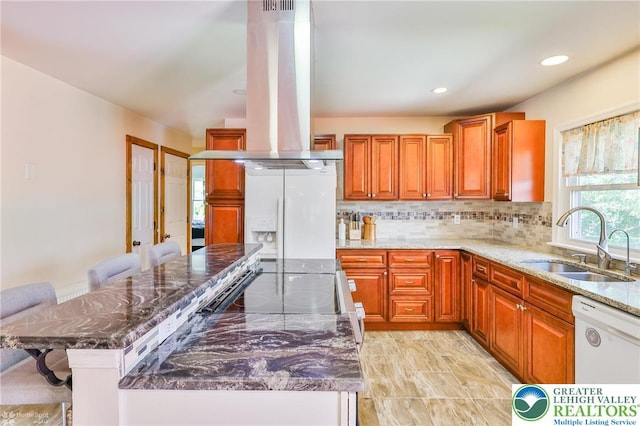 236 Moorestown Rd, Bushkill Twp, PA 18091 - kitchen with island exhaust hood, refrigerator with ice dispenser, dishwasher, dark stone counters, and tasteful backsplash