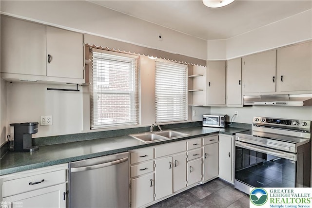 650 Highland Ave, Bethlehem City, PA 18018 - kitchen featuring appliances with stainless steel finishes, under cabinet range hood, dark countertops, open shelves, and dark tile patterned flooring