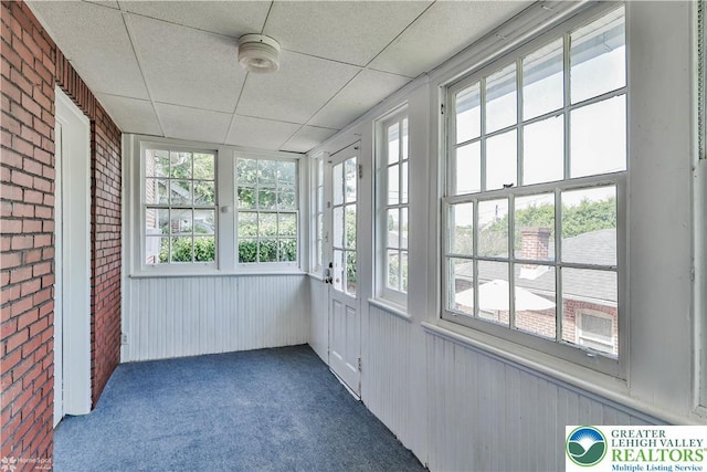 650 Highland Ave, Bethlehem City, PA 18018 - unfurnished sunroom featuring carpet, brick wall, and wood walls