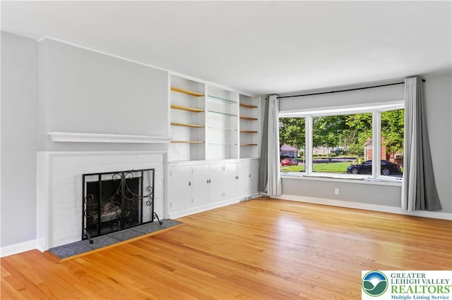 1882 Ridgelawn Ave, Bethlehem City, PA 18018 - unfurnished living room featuring wood finished floors and a brick fireplace