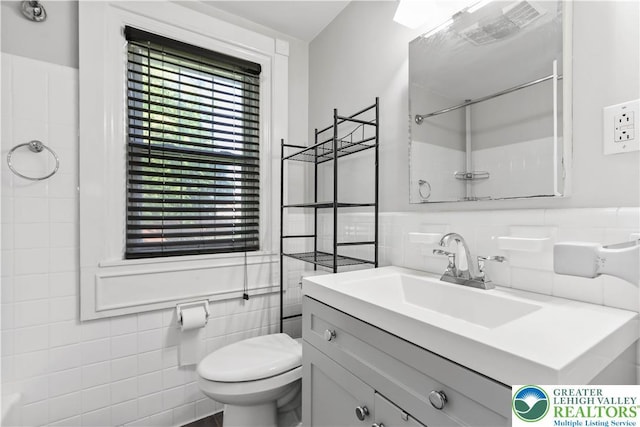 1882 Ridgelawn Ave, Bethlehem City, PA 18018 - bathroom with tile walls, vanity, a wainscoted wall, and a shower