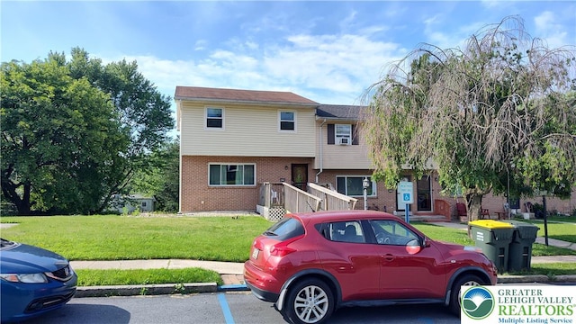 5278 Herman St, Heidelberg Twp, PA 18053 - view of front of house featuring brick siding, a front yard, and uncovered parking