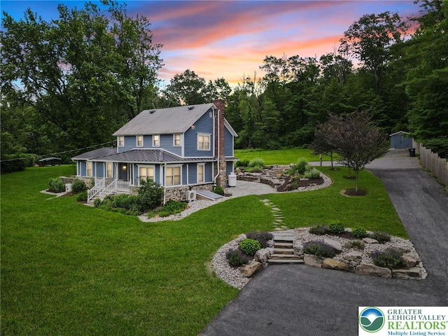 3224 Middle Easton Belmont Pike, Hamilton Twp, PA 18360 - view of front facade featuring stone siding, a chimney, a porch, and a lawn