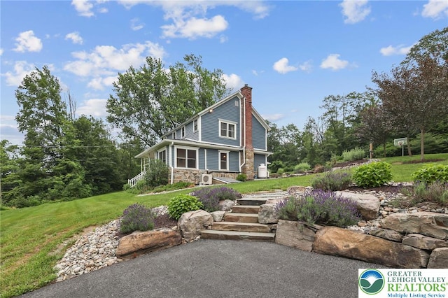 3224 Middle Easton Belmont Pike, Hamilton Twp, PA 18360 - view of front of house with stone siding, a chimney, and a front yard