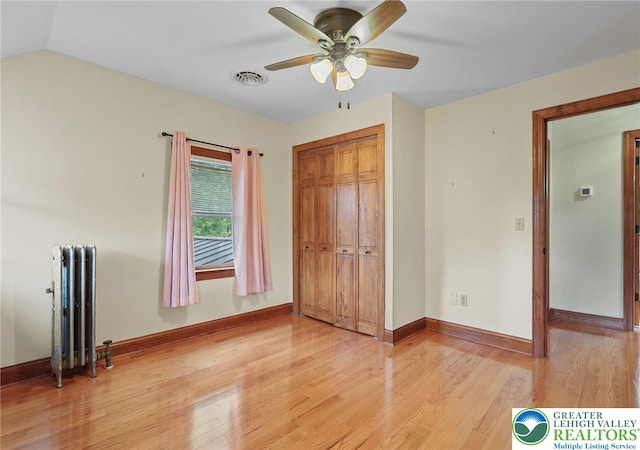 3224 Middle Easton Belmont Pike, Hamilton Twp, PA 18360 - unfurnished bedroom featuring radiator heating unit, light wood finished floors, a closet, and a ceiling fan