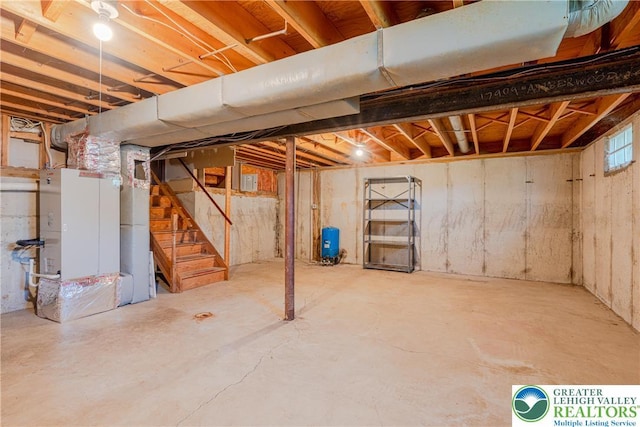 4834 Maple St, Lower Mt Bethel Twp, PA 18013 - basement featuring a water pressure tank, stairway, and heating unit