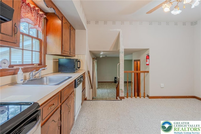 4834 Maple St, Lower Mt Bethel Twp, PA 18013 - kitchen with black microwave, brown cabinetry, white dishwasher, light countertops, and range hood