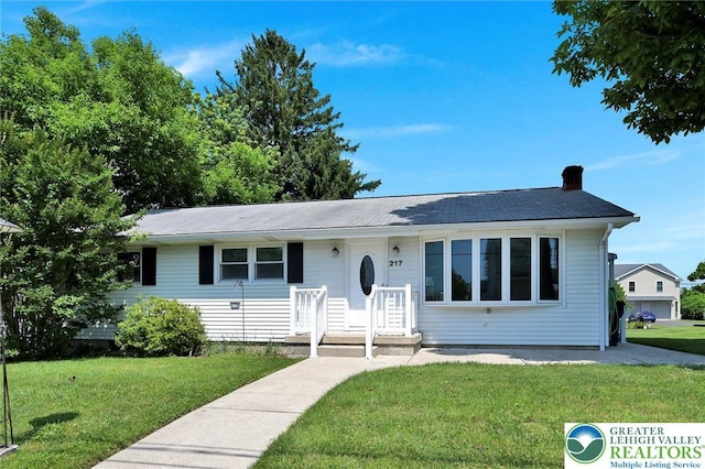 217 2nd St, Walnutport Boro, PA 18088 - view of front of house with a front yard and a chimney