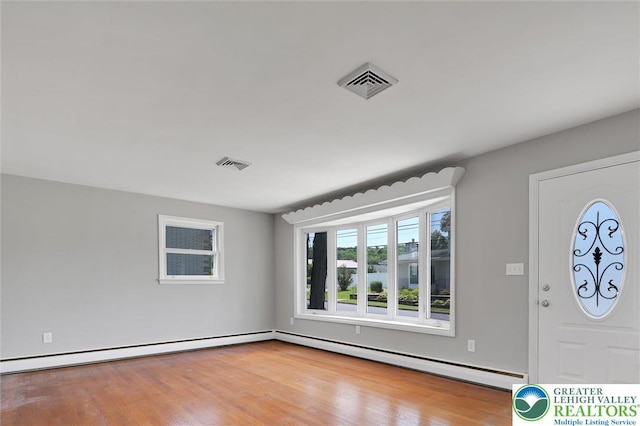 217 2nd St, Walnutport Boro, PA 18088 - entrance foyer with baseboard heating, wood finished floors, and a baseboard heating unit
