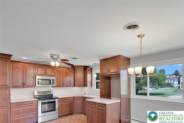 217 2nd St, Walnutport Boro, PA 18088 - kitchen with stainless steel appliances, plenty of natural light, light countertops, and brown cabinets