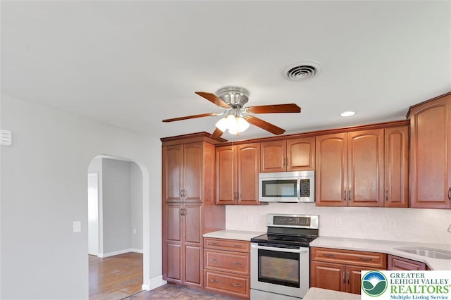 217 2nd St, Walnutport Boro, PA 18088 - kitchen with stainless steel appliances, arched walkways, a ceiling fan, light countertops, and recessed lighting