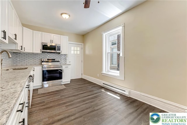 1744 W Chew St, Allentown City, PA 18104 - kitchen featuring stainless steel appliances, white cabinetry, dark wood-style flooring, backsplash, and light stone counters