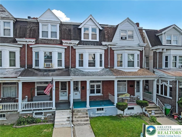 1744 W Chew St, Allentown City, PA 18104 - view of property featuring covered porch, brick siding, roof with shingles, and cooling unit