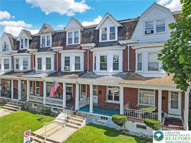 1744 W Chew St, Allentown City, PA 18104 - townhome / multi-family property with brick siding, covered porch, a front lawn, and a residential view