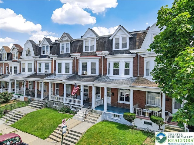 1744 W Chew St, Allentown City, PA 18104 - townhome / multi-family property with a residential view, brick siding, a porch, and a front yard