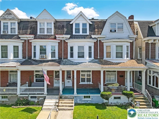 1744 W Chew St, Allentown City, PA 18104 - townhome / multi-family property featuring a porch, brick siding, and cooling unit