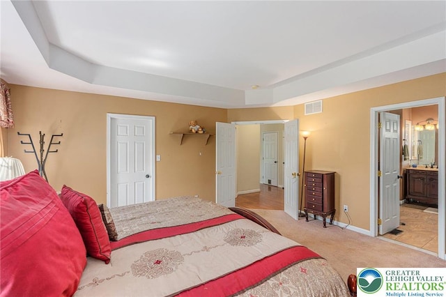 441 Sawgrass Dr, Upper Macungie Twp, PA 18104 - carpeted bedroom featuring a raised ceiling and ensuite bath