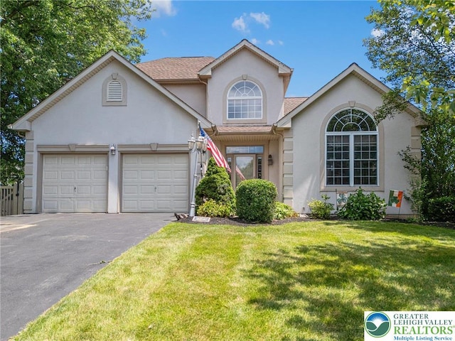 441 Sawgrass Dr, Upper Macungie Twp, PA 18104 - traditional-style home featuring stucco siding, asphalt driveway, an attached garage, a front yard, and a shingled roof