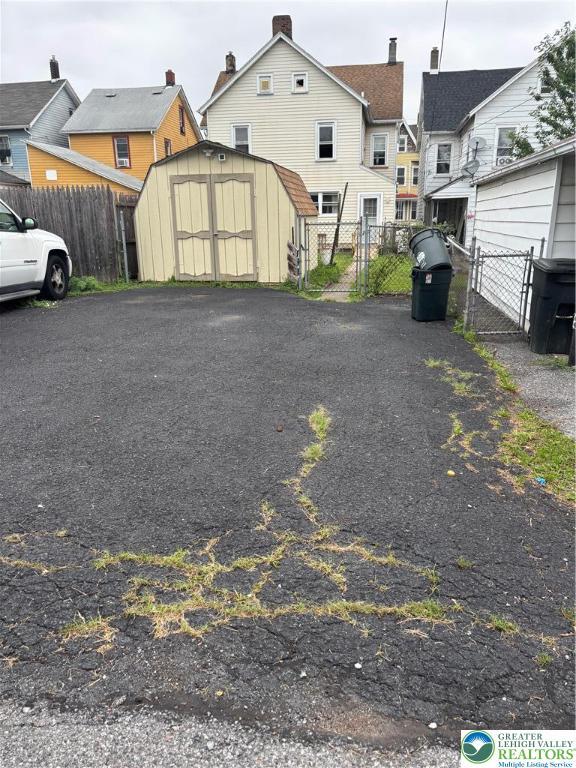 232 W Nesquehoning St, Easton, PA 18042 - rear view of property with a storage shed and a gate