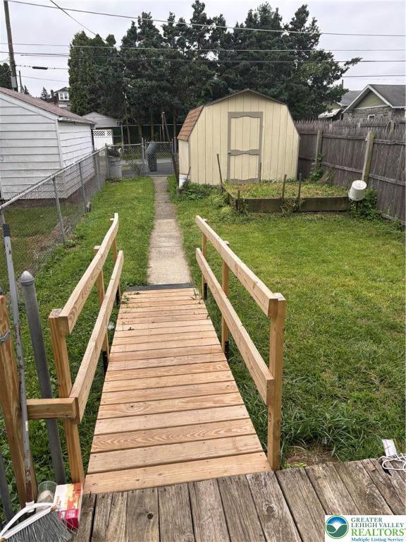 232 W Nesquehoning St, Easton, PA 18042 - deck featuring a fenced backyard and a storage shed