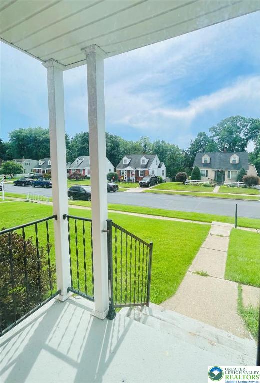 95 7th St, Whitehall Twp, PA 18052 - covered porch with a residential view and a lawn