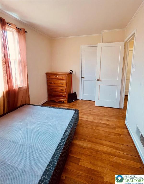 95 7th St, Whitehall Twp, PA 18052 - bedroom with wood finished floors and crown molding
