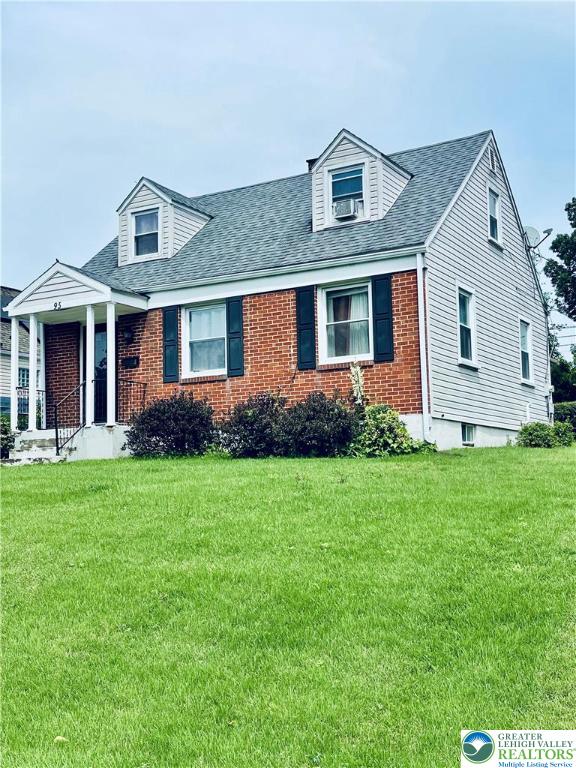 95 7th St, Whitehall Twp, PA 18052 - cape cod home with a front yard, brick siding, and roof with shingles