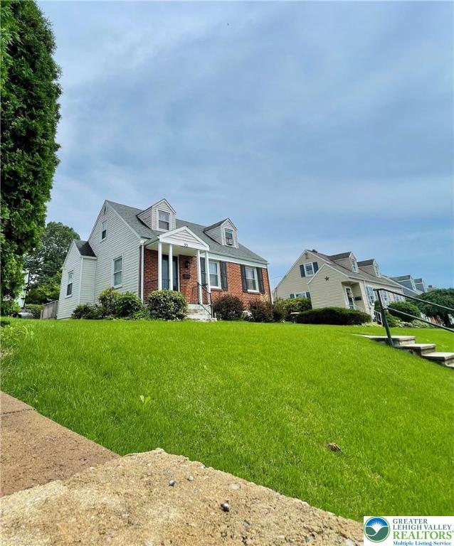 95 7th St, Whitehall Twp, PA 18052 - cape cod home with brick siding and a front lawn