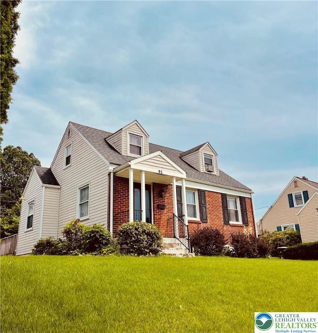 95 7th St, Whitehall Twp, PA 18052 - cape cod-style house featuring brick siding and a front lawn
