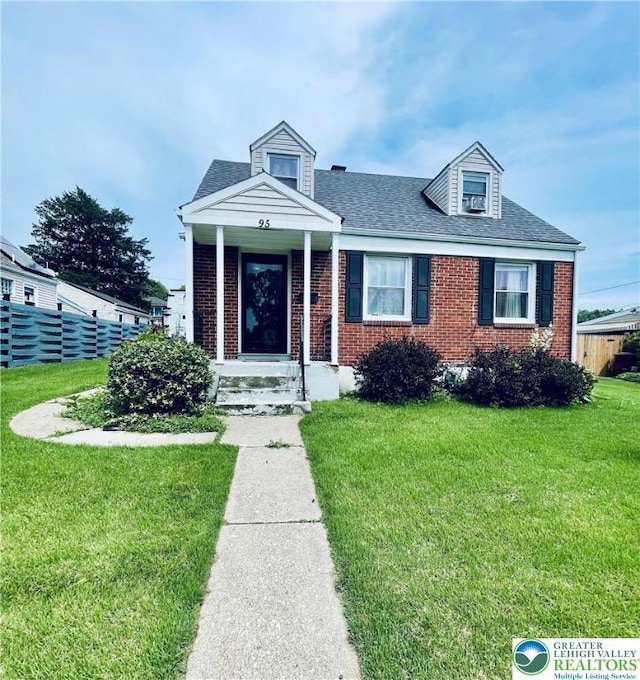 95 7th St, Whitehall Twp, PA 18052 - view of front of house with brick siding, a front lawn, and roof with shingles