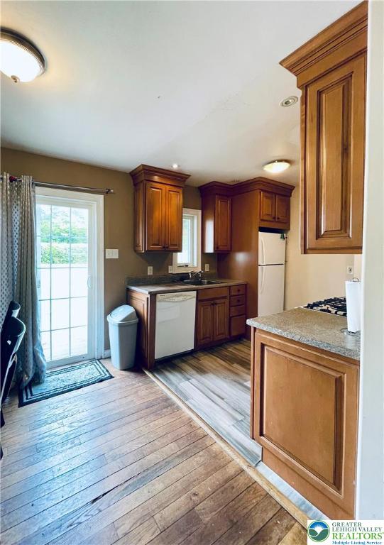 95 7th St, Whitehall Twp, PA 18052 - kitchen with white appliances, light wood-style flooring, brown cabinets, and recessed lighting