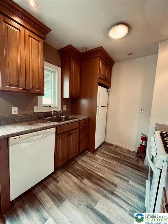95 7th St, Whitehall Twp, PA 18052 - kitchen with white appliances, brown cabinets, and light wood finished floors