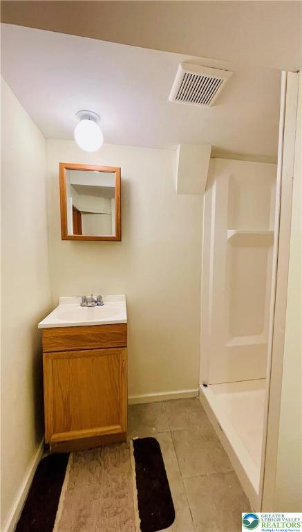 95 7th St, Whitehall Twp, PA 18052 - full bathroom featuring vanity, tile patterned floors, and a shower