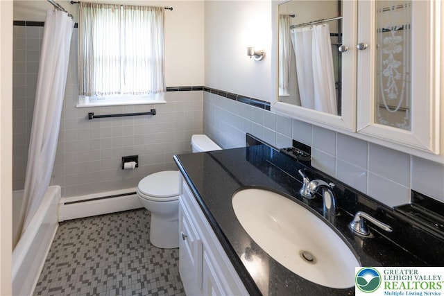bathroom featuring a baseboard heating unit, vanity, tile patterned floors, a wainscoted wall, and shower / bath combination with curtain