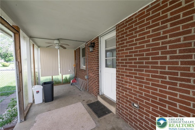 unfurnished sunroom with ceiling fan