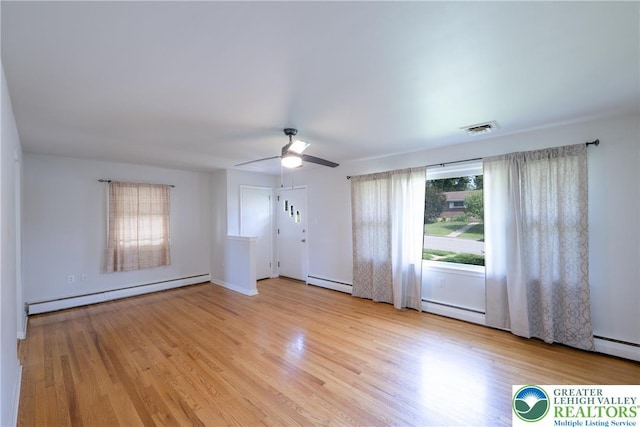 entryway with baseboard heating, ceiling fan, wood finished floors, and a baseboard radiator