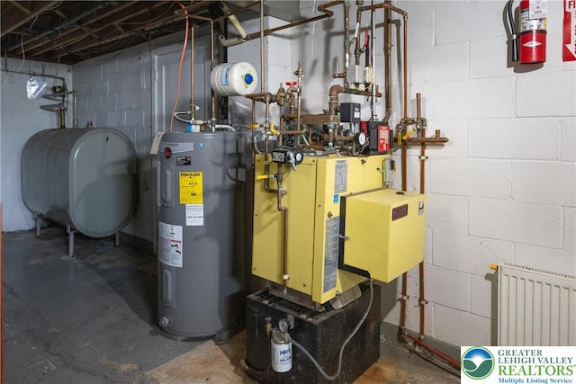 utility room with electric water heater, heating fuel, and radiator