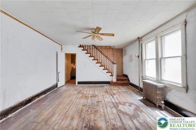 232 W Patterson St, Lansford Boro, PA 18232 - unfurnished living room featuring radiator, stairway, hardwood / wood-style flooring, a ceiling fan, and ornamental molding