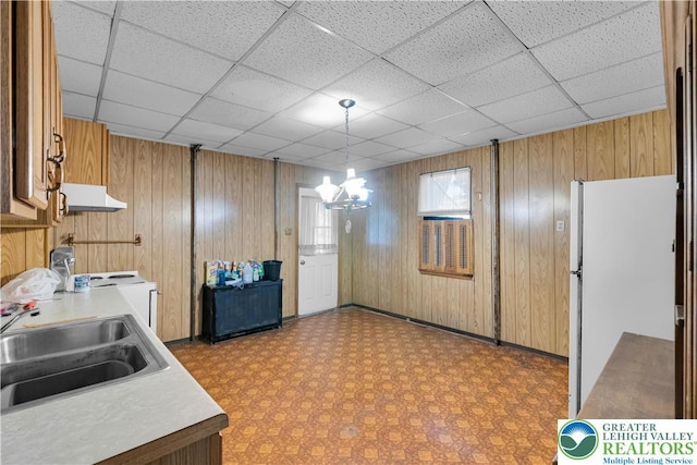 232 W Patterson St, Lansford Boro, PA 18232 - kitchen with freestanding refrigerator, light countertops, wood walls, light flooring, and range hood