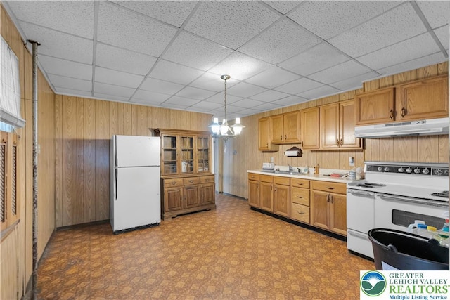232 W Patterson St, Lansford Boro, PA 18232 - kitchen featuring white appliances, under cabinet range hood, wood walls, light floors, and light countertops