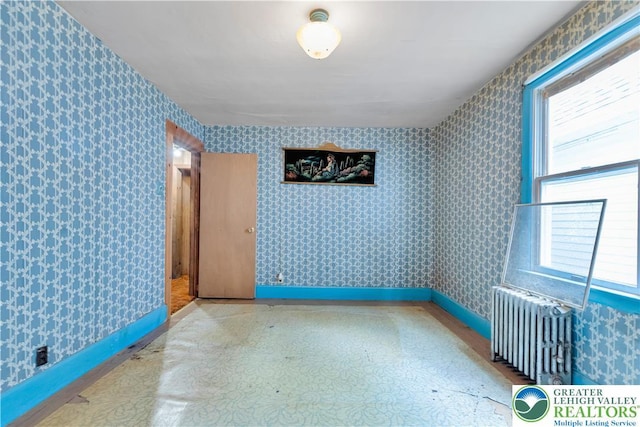232 W Patterson St, Lansford Boro, PA 18232 - empty room with wallpapered walls and radiator heating unit