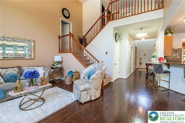 6 Westridge Ct, Middle Smithfield Twp, PA 18302 - living area with wood finished floors, stairs, and a towering ceiling
