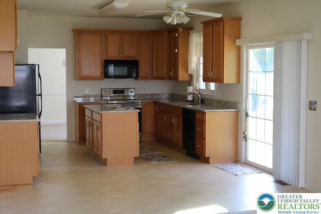 2509 Somerset Rd, Whitehall Twp, PA 18052 - kitchen featuring black appliances, a center island, ceiling fan, light countertops, and light flooring