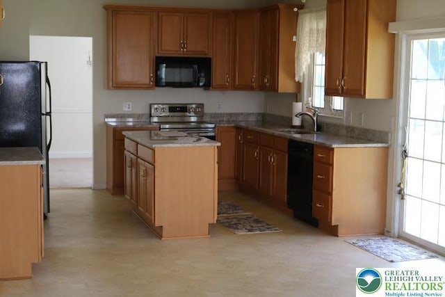 2509 Somerset Rd, Whitehall Twp, PA 18052 - kitchen featuring black appliances, a center island, healthy amount of natural light, and light flooring