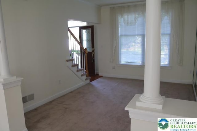 2509 Somerset Rd, Whitehall Twp, PA 18052 - foyer entrance with ornate columns, plenty of natural light, and carpet flooring