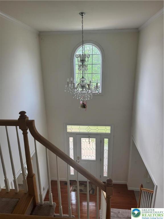 2509 Somerset Rd, Whitehall Twp, PA 18052 - entryway with a chandelier, wood finished floors, stairway, a towering ceiling, and ornamental molding