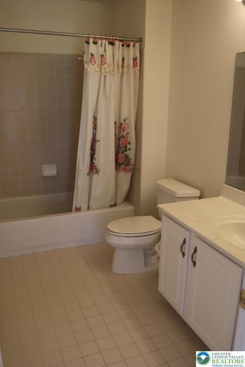 2509 Somerset Rd, Whitehall Twp, PA 18052 - bathroom featuring tile patterned flooring, vanity, and shower / tub combo