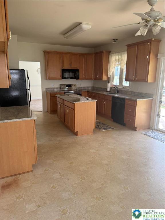 2509 Somerset Rd, Whitehall Twp, PA 18052 - kitchen with black appliances, healthy amount of natural light, a kitchen island, and ceiling fan