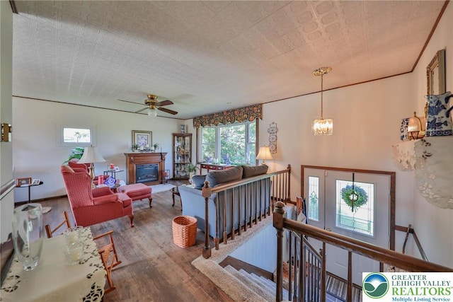 70 Faust N Rd, Pa, PA 19507 - living room with wood finished floors, a chandelier, a glass covered fireplace, and a ceiling fan